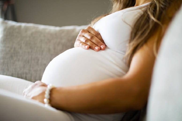 pregnant woman holding belly