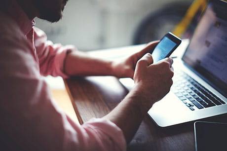 Man using both hands to text