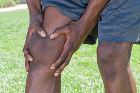 Man holding his painful knee