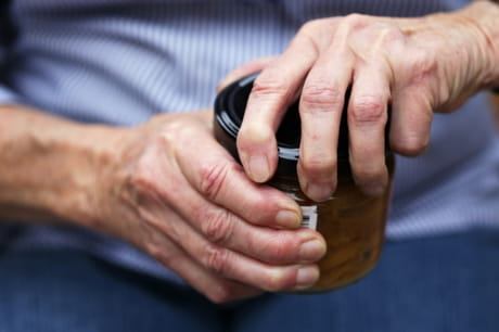 Man trying to open jar.
