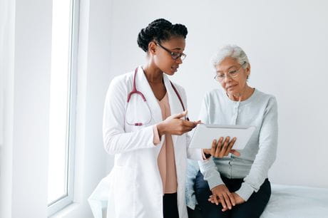 Doctor and patient review mammogram results. 