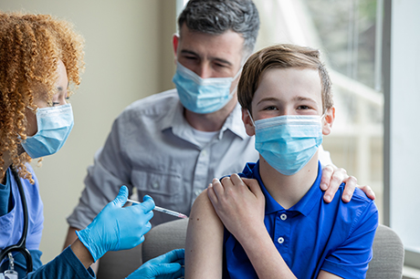 Young boy getting COVID-19 vaccine