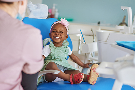 A child sitting in a dentist chair