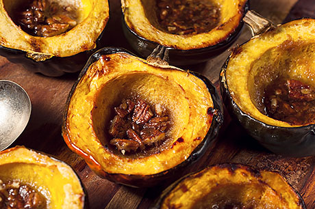 A prepared serving of orange honeyed acorn squash.