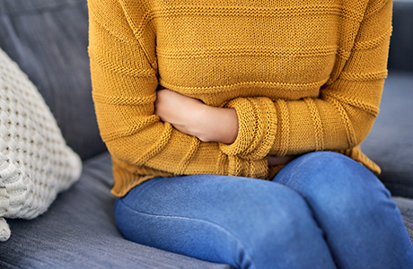 A woman holding her stomach.